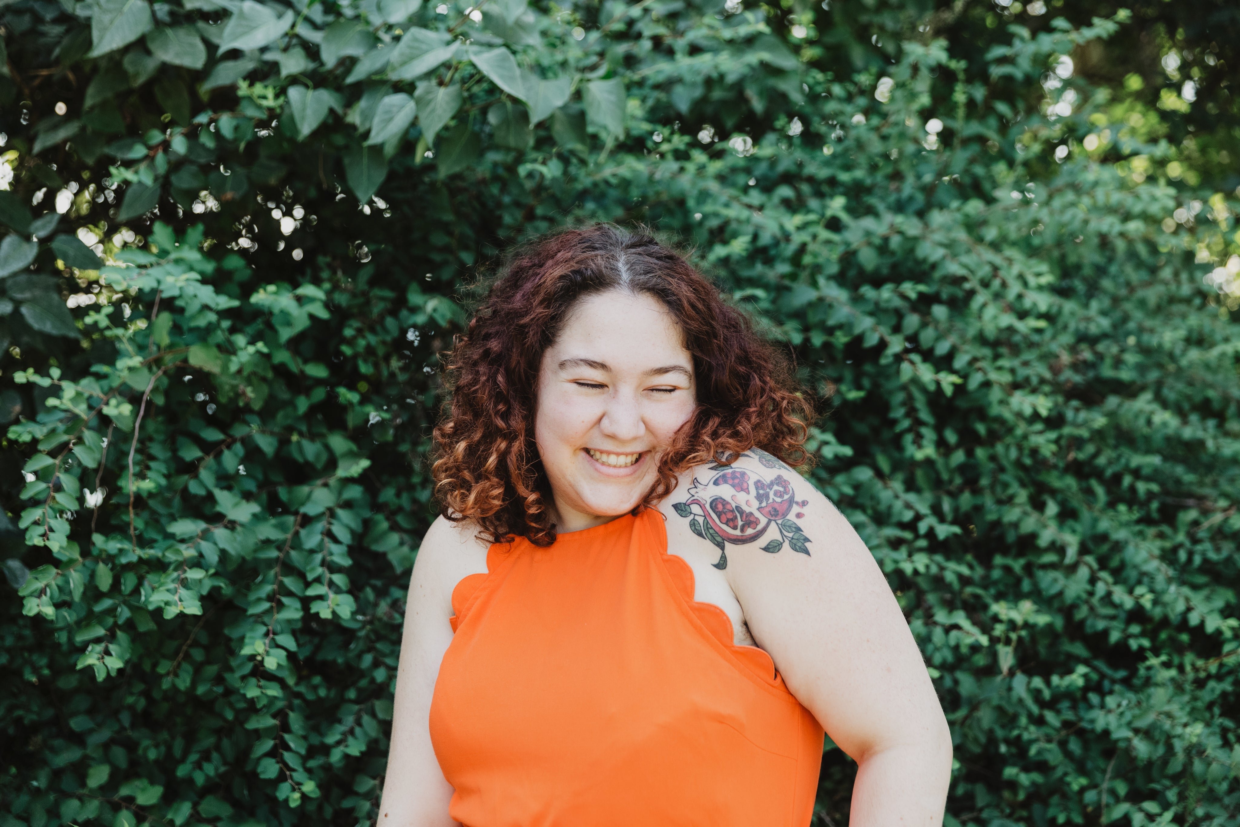 files/young-woman-in-orange-shirt-with-pomegranate-tattoo_1.jpg